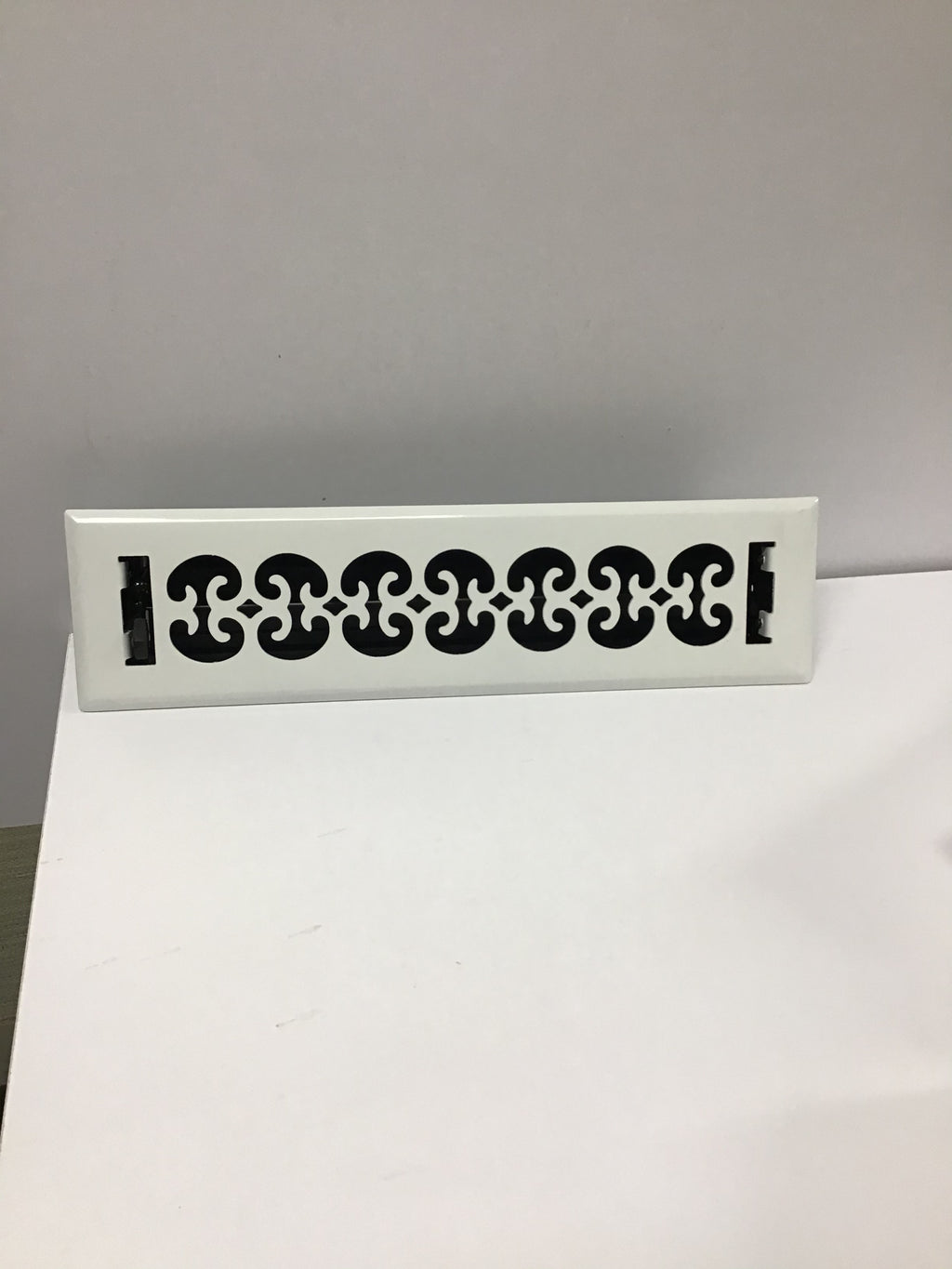 White ornate heating/cooling vent